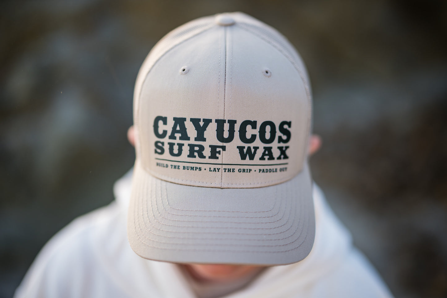 Khaki trucker hat with embroidered navy Cayucos Surf Wax Heritage logo