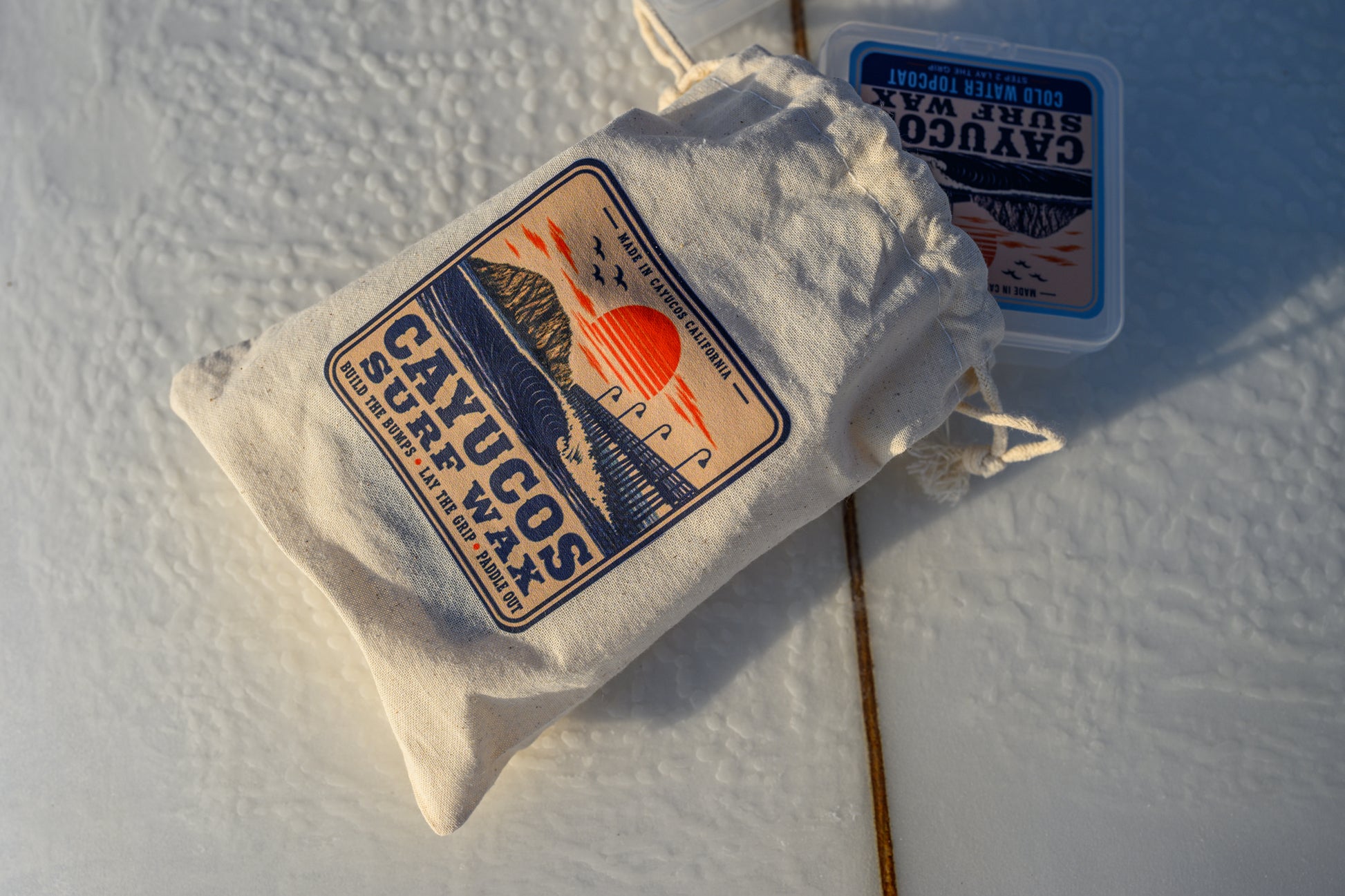Cayucos Surf Wax Signature Stash Pack with reusable wax cases and muslin storage bag.