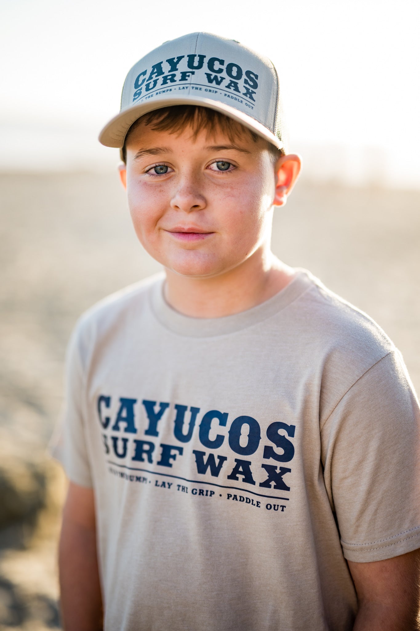 Kids cream Cayucos Surf Wax Heritage T-shirt with navy logo.