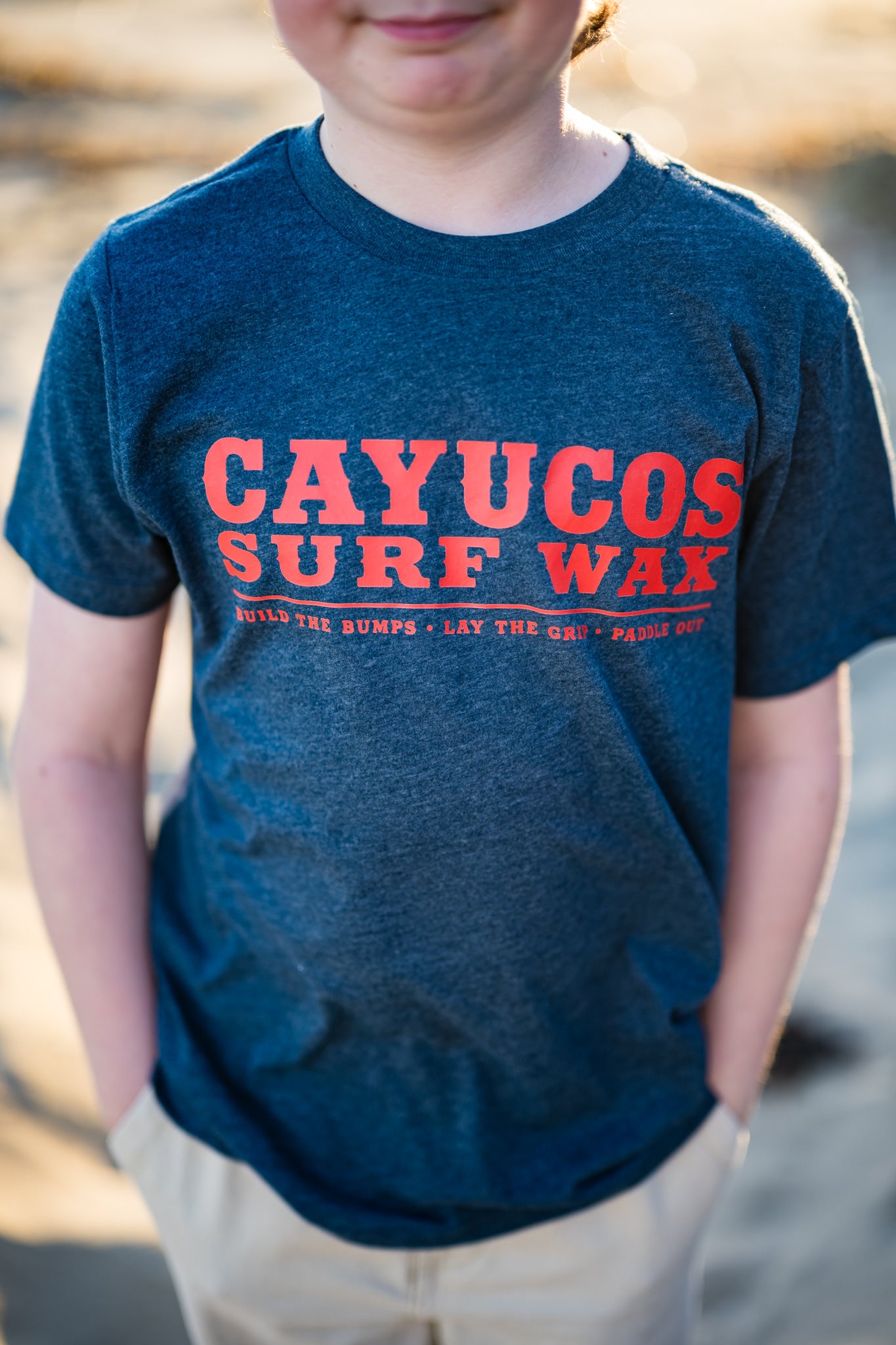 Kids blue Cayucos Surf Wax Heritage T-shirt with orange logo