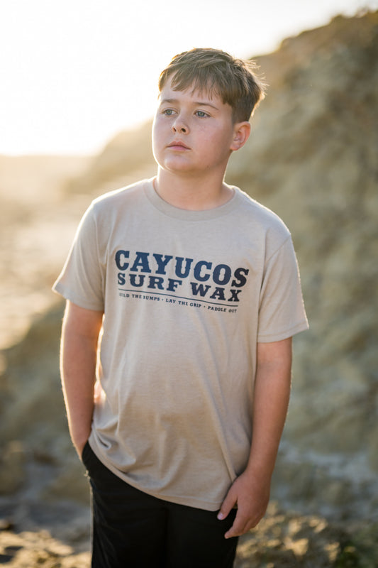 Kids cream Cayucos Surf Wax Heritage T-shirt with navy logo.