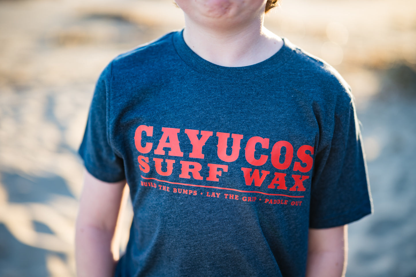 Kids blue Cayucos Surf Wax Heritage T-shirt with orange logo