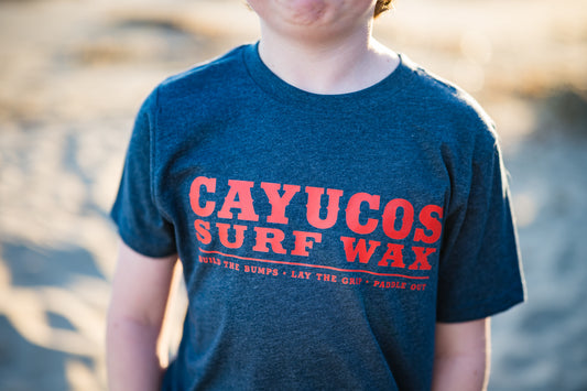 Kids blue Cayucos Surf Wax Heritage T-shirt with orange logo