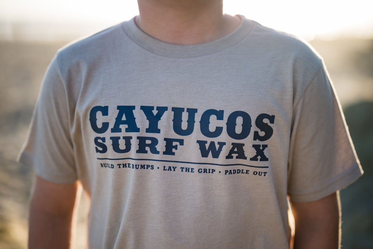 Kids cream Cayucos Surf Wax Heritage T-shirt with navy logo.