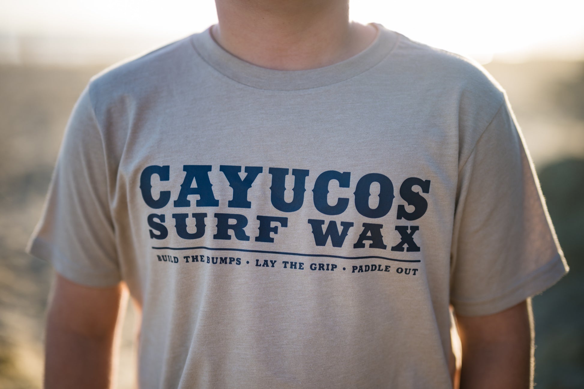 Kids cream Cayucos Surf Wax Heritage T-shirt with navy logo.