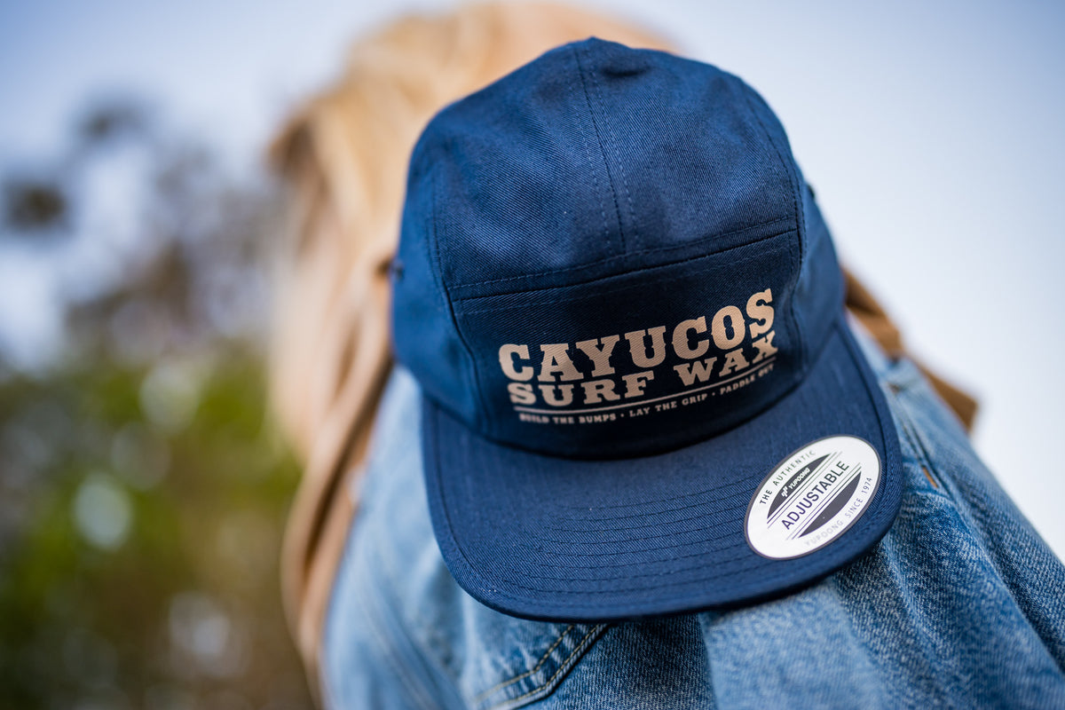  Cayucos Surf Wax navy blue flat brimmed jockey cap with adjustable closure